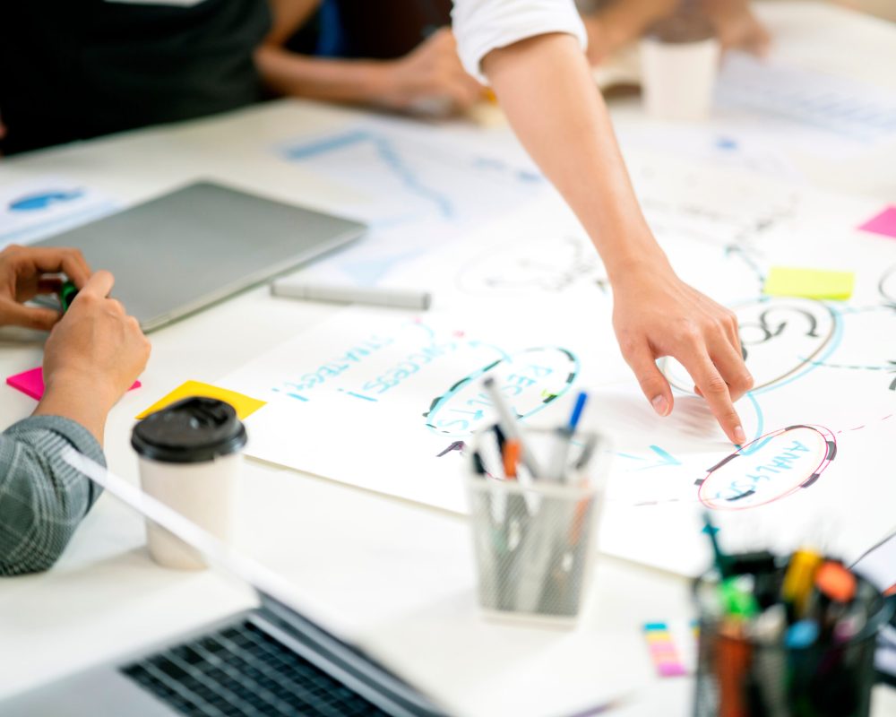 close up hand of business creative staff presentation with organize chart diagram and work flow to client and friend